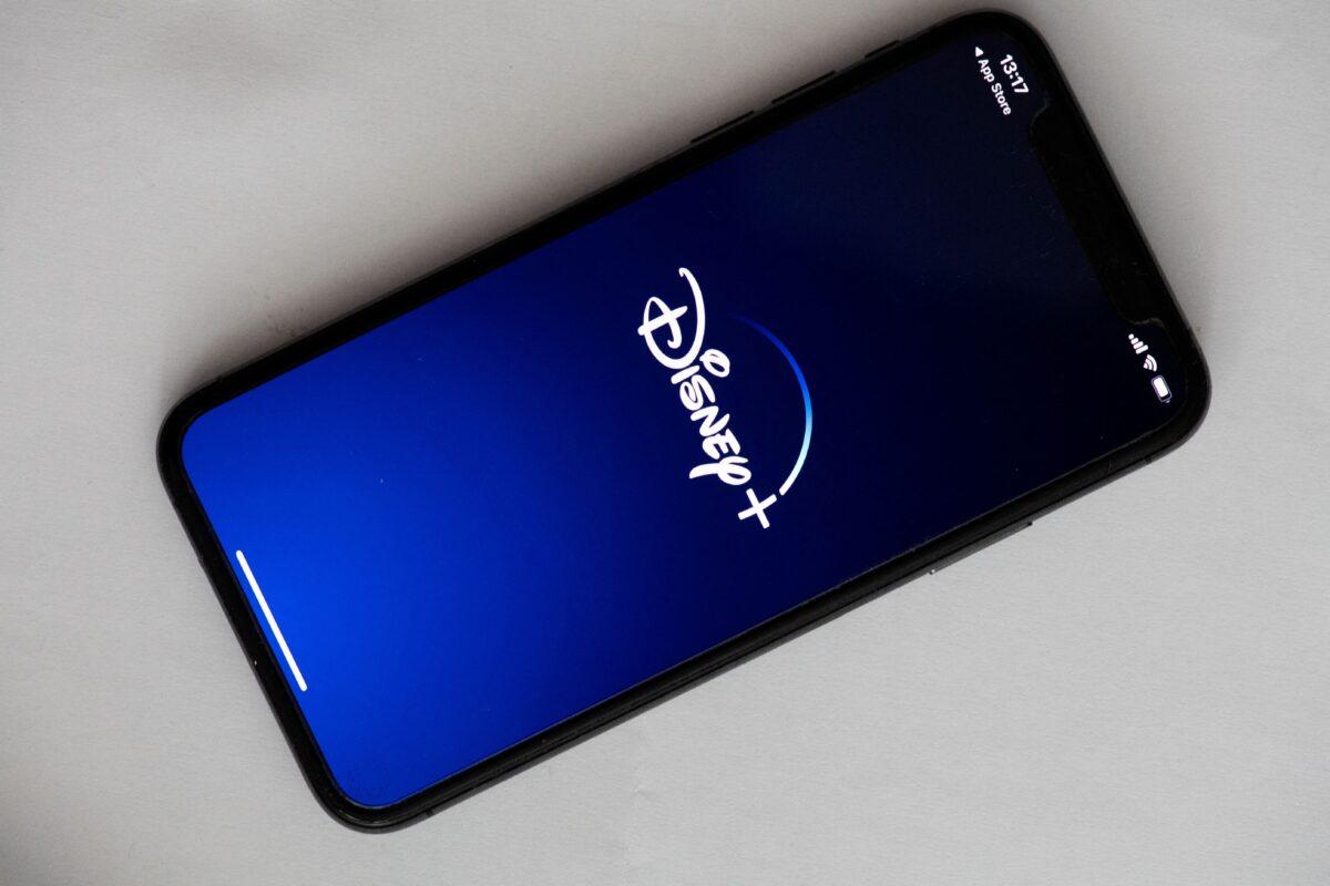 The logo of the U.S. video on demand application Disney+ on the screen of a phone in Paris on May 27, 2020. (Martin Bureau/AFP via Getty Images)