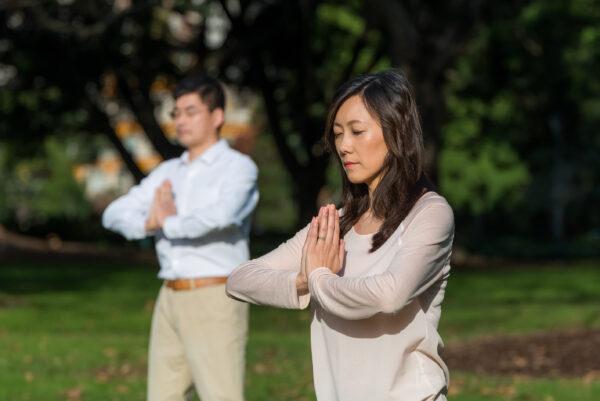 People practice the exercises of Falun Dafa in a park in Sydney, Australia, on June 26, 2017. (Emma Morley)