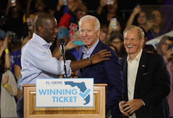 Former Vice President Joe Biden is greeted by Florida Democratic gubernatorial nominee Andrew Gillum and then-U.S. Sen. Bill Nelson (D-Fla.) during a campaign rally held at the University of South Florida Campus Recreation Building in Tampa on Oct. 22, 2018. (Joe Raedle/Getty Images)