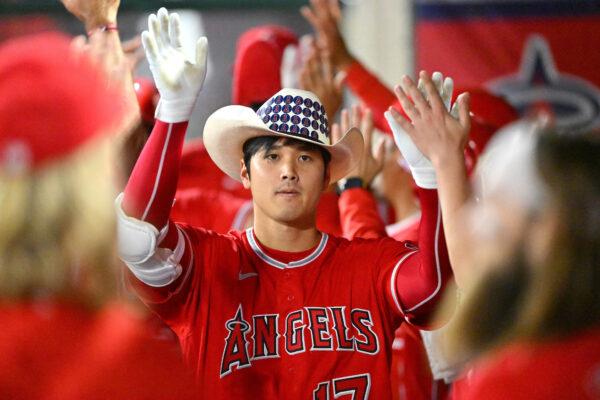 Shohei Ohtani #17 of the Los Angeles Angels is congratulated in the dugout after hitting a 3-run home run in the sixth inning of the game against the Kansas City Royals at Angel Stadium of Anaheim, in Anaheim, on June 21, 2022. (Jayne Kamin-Oncea/Getty Images)