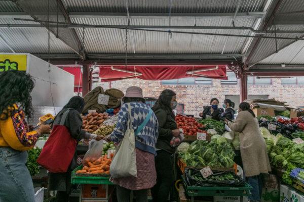 People shop for fruits and vegetables at the Queen Victoria Market in Melbourne, Australia, on Oct. 24, 2021. (Asanka Ratnayake/Getty Images)