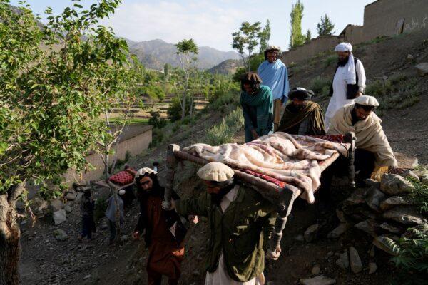 Afghans carry a relative killed in an earthquake to a burial site l in Gayan village, in Paktika Province, Afghanistan, on June 23, 2022. (Ebrahim Nooroozi/AP Photo)