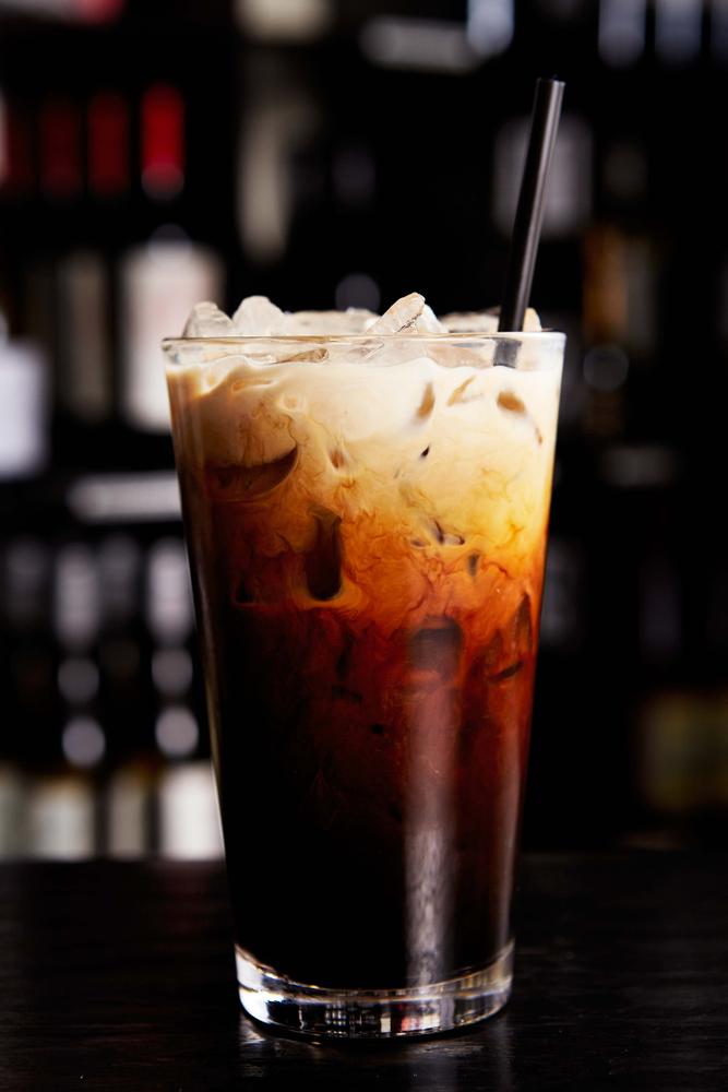  Thai iced coffee is a strong brew of Robusta beans roasted along with grains or seeds and brown sugar, sweetened with condensed milk and often evaporated milk. (Bai Tong Restaurant/Shutterstock)