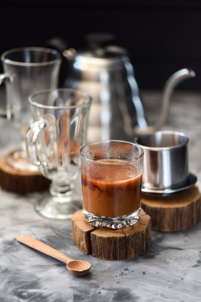 A special phin filter is used to make Vietnamese iced coffee: first brewed over condensed milk, then poured over ice. (Alexey Borodin/Shutterstock)