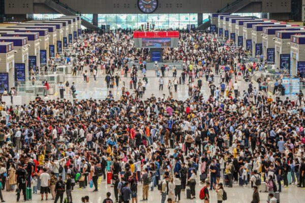 Passengers wait for their train to arrive at the Zhengzhou East railway station in Zhengzhou, in China's central Henan Province, on Sept. 30, 2021. (STR/AFP via Getty Images)