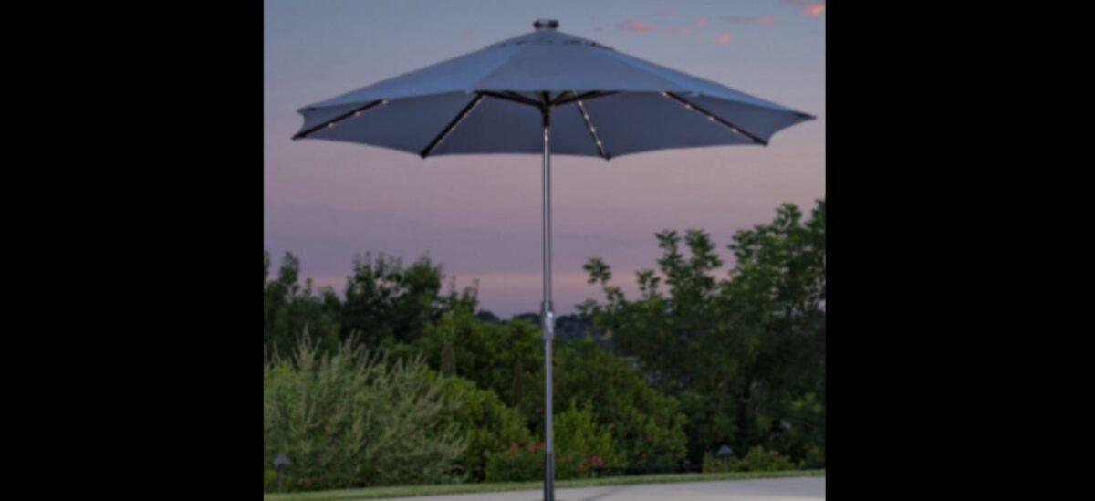 The recalled 10-foot Solar LED Market Umbrella with a round back solar puck at the top of the umbrella (US CPSC)