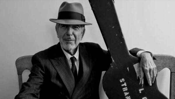 Leonard Cohen with his guitar ready to go out on tour. (Courtesy of the Cohen Estate.)