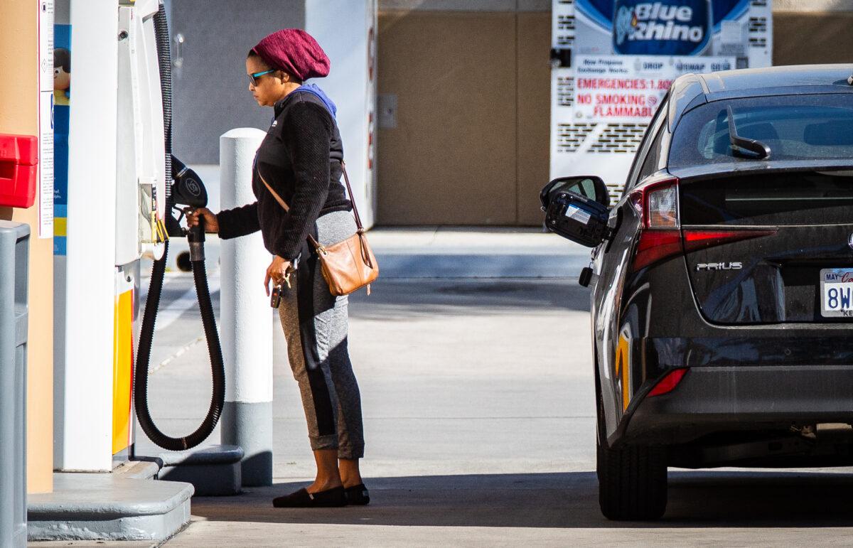 A driver fills her car with gas amid record high petrol prices, in Irvine, California, on Feb. 23, 2022. (John Fredricks/The Epoch Times)