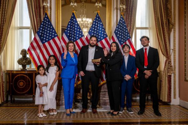 Rep.-elect Mayra Flores (R-TX) stands with her family and Speaker of the House Nancy Pelosi (D-CA) for a portrait after being sworn-in on June 21, 2022 in Washington, DC. (Brandon Bell/Getty Images)
