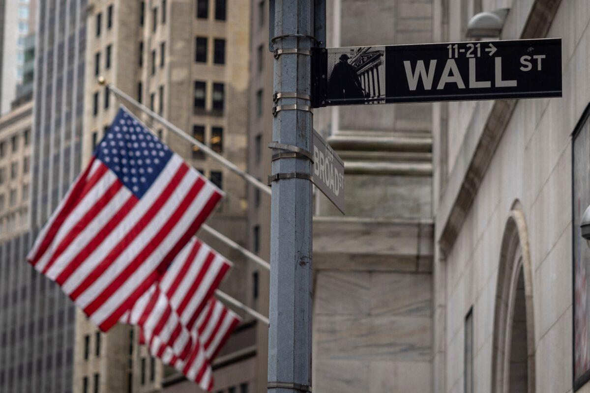 The sign for Wall Street with U.S. flags outside the New York Stock Exchange in New York on June 16, 2022. (Yuki Iwamura/AFP via Getty Images)