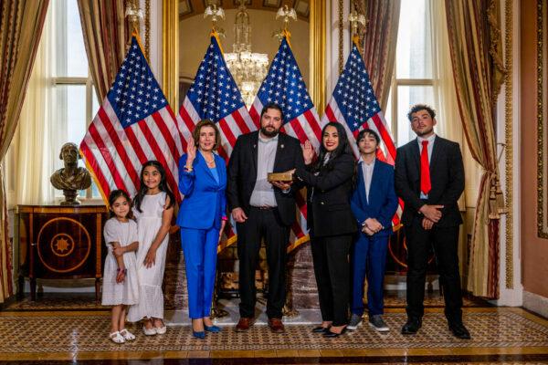 Rep.-elect Mayra Flores (R-TX) stands with her family and Speaker of the House Nancy Pelosi (D-CA) for a portrait after being sworn-in on June 21, 2022 in Washington, DC. (Brandon Bell/Getty Images)