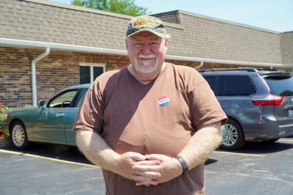 Charles McCloud stands outside of a polling site in Palos Hills, Ill., on June 28, 2022. (Cara Ding/The Epoch Times)