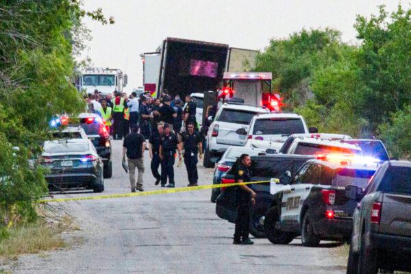 Law enforcement officers work at the scene where people were found dead inside a trailer truck in San Antonio, Texas, on June 27, 2022. (Kaylee Greenlee Beal/Reuters)