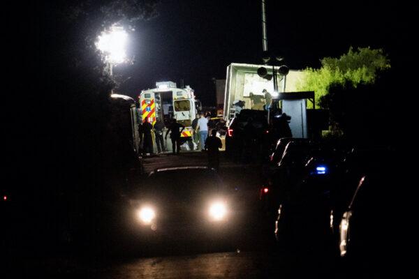 Law enforcement officers work at the scene where people were found dead inside a trailer truck in San Antonio, Texas, on June 28, 2022. (Reuters/Go Nakamura)