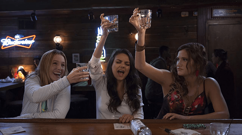 (L–R) Kiki (Kristen Bell), Amy (Mila Kunis), and Carla (Kathryn Hahn) behave badly in a bar, in “Bad Moms” (STX Productions)