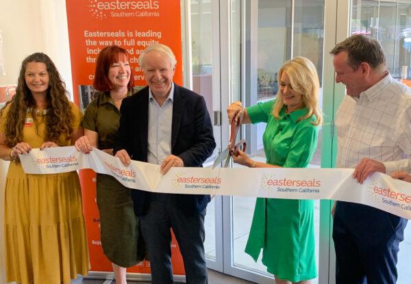 Molly and David Pyott (C) cut the ribbon of the newly developed Easterseals Pyott Center in Santa Ana, Calif., on June 28, 2022. (John Fredricks/The Epoch Times)