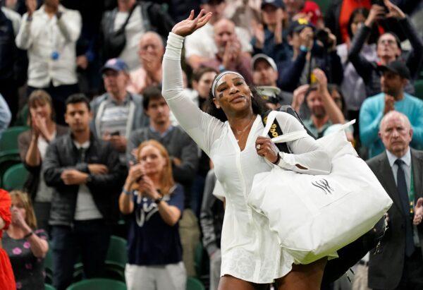 Serena Williams of the US waves as she leaves the court after losing to France's Harmony Tan in a first round women's singles match on day two of the Wimbledon tennis championships in London, on June 28, 2022. (Alberto Pezzali/AP Photo)