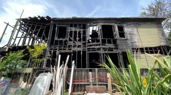 The skeleton of a burnt house in a neighborhood in West Oakland, Calif., on May 26, 2022. (Cynthia Cai/NTD Television)