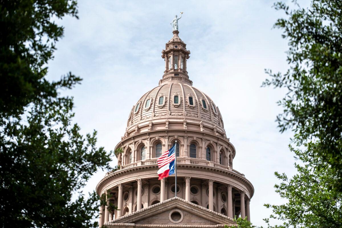  The United States and Texas state flags fly outside the state Capitol building in Austin, Texas, on July 12, 2021. (Sergio Flores/Getty Images)