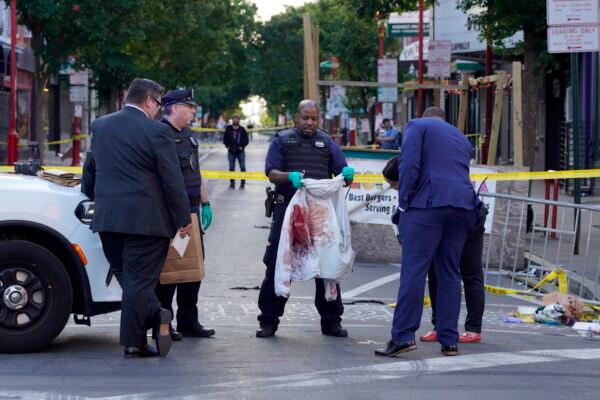 Philadelphia Police investigators work the scene of a fatal overnight shooting on South Street in Philadelphia, on June 5, 2022. (Michael Perez/AP Photo)