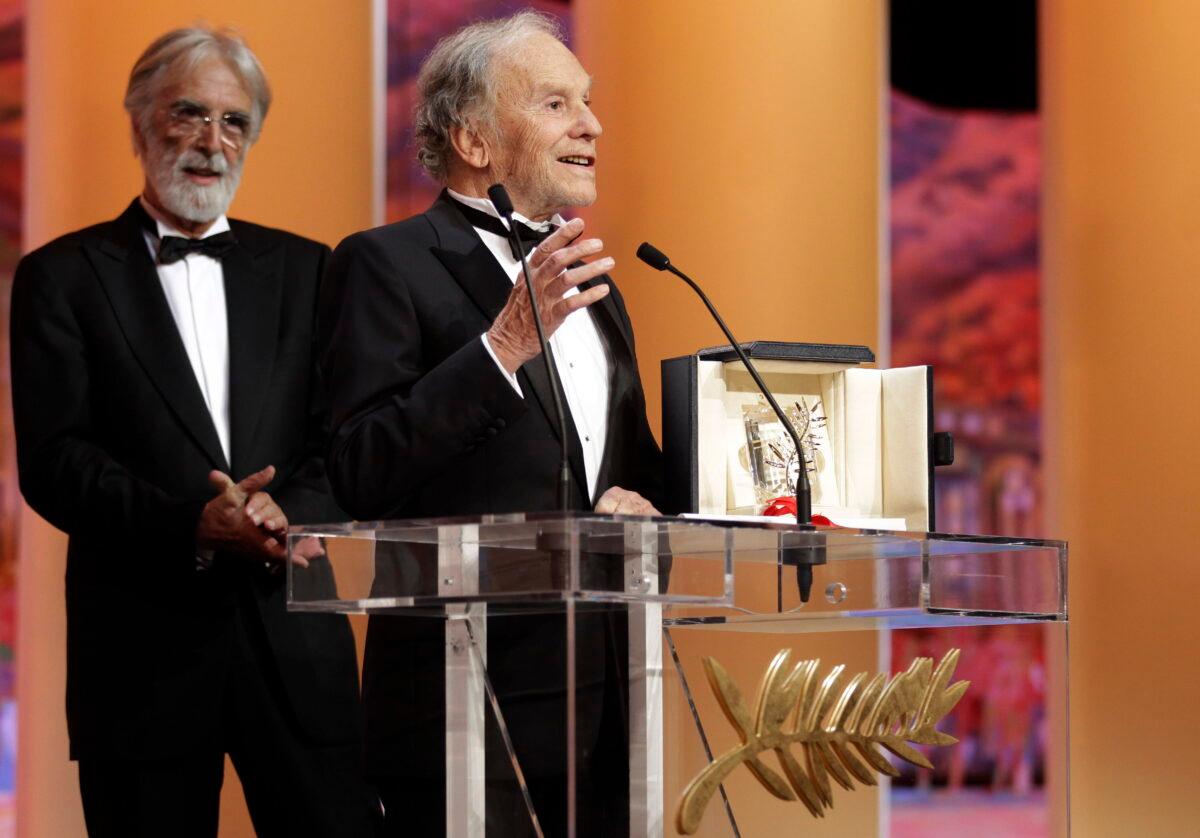 Actor Jean-Louis Trintignant (R) speaks as director Michael Haneke looks on after he is presented with the Palme d'Or award for Love during the awards ceremony at the 65th international film festival, in Cannes, southern France, on May 27, 2012. (Lionel Cironneau/AP Photo)