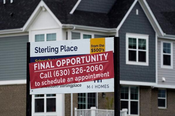 An advertising sign for building land stands in front of a new home construction site in Northbrook, Ill. on May 5, 2022. (Nam Y. Huh/AP Photo)