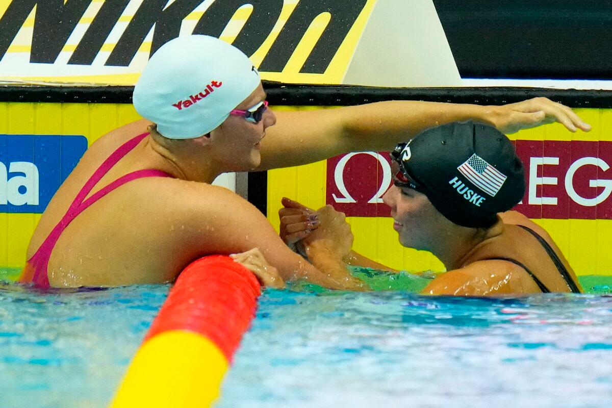 Winner Torri Huske of the United States (R) and second placed Marie Wattel of France celebrate after finishing the Women 100m Butterfly final at the 19th FINA World Championships in Budapest, Hungary, on June 19, 2022. (Petr David Josek/AP Photo)