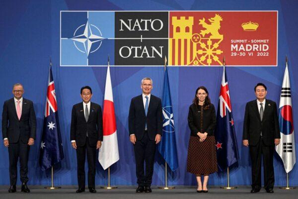(L to R) Australia's Prime Minister Anthony Albanese, Japan's Prime Minister Fumio Kishida, NATO Secretary General Jens Stoltenberg, former New Zealand Prime Minister Jacinda Ardern, and South Korea's President Yoon Suk-yeol pose for a group photograph ahead of an Indo-Pacific Partners meeting during the NATO summit at the Ifema congress centre in Madrid, on June 29, 2022. (Pierre-Philippe Marcou/AFP via Getty Images)