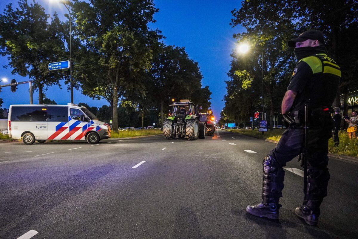 A Dutch police officer stands guard as dutch police close access to Apeldoorn on the A1 highway to stop potential farmers demonstrating against the Dutch government's plans to cut nitrogen greenhouse gas emissions, on June 29, 2022. (Jeroen Jumelet/ANP/AFP via Getty Images)