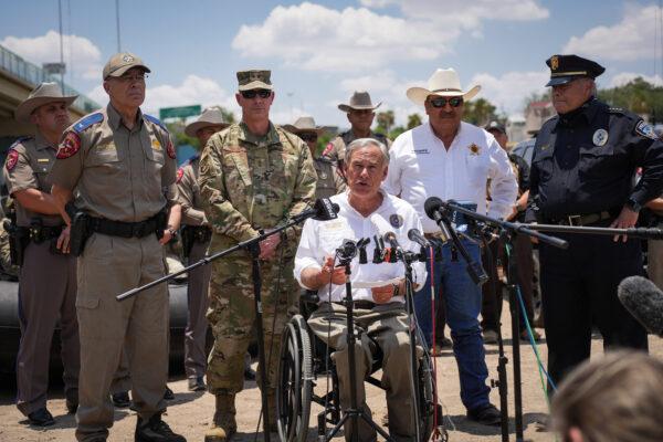 Texas Gov. Greg Abbott, flanked by state and local law enforcement officials, speaks to media in Eagle Pass, Texas, on June 29, 2022. (Charlotte Cuthbertson/The Epoch Times)
