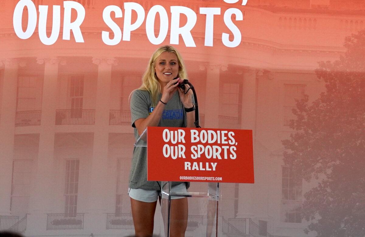 Riley Gaines Barker, a former University of Kentucky swimmer who tied for fifth place against transgender swimmer Lia Thomas at the NCAA Championships in March, speaks at the “Our Bodies, Our Sports” rally at Freedom Plaza in Washington on June 23, 2022. (Terri Wu/The Epoch Times)