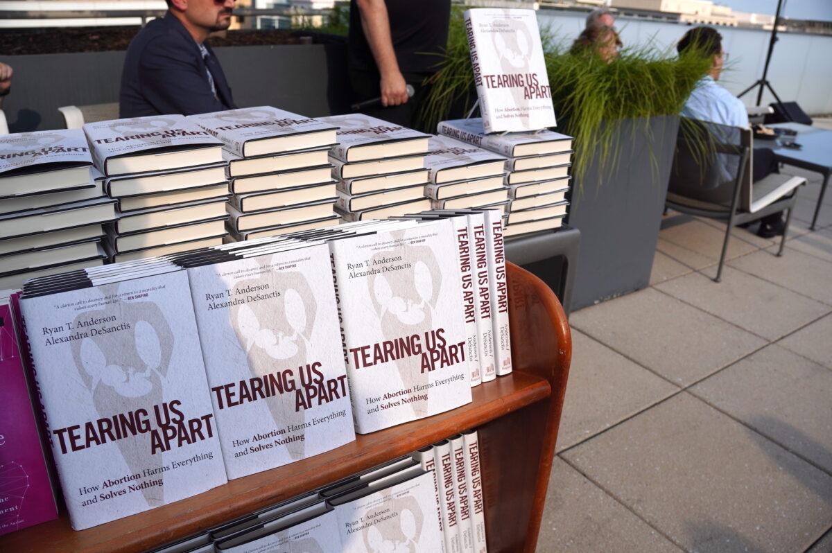 Copies of the book “Tearing Us Apart: How Abortion Harms Everything and Solves Nothing” are presented at an event hosted by the Catholic Information Center in Washington on June 29, 2022. (Terri Wu/The Epoch Times)