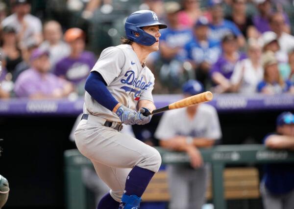 Los Angeles Dodgers' James Outman follows the flight of his RBI-double off Colorado Rockies relief pitcher Jake Bird in the eighth inning of a baseball game in Denver, Sunday, July 31, 2022. (David Zalubowski/AP Photo)