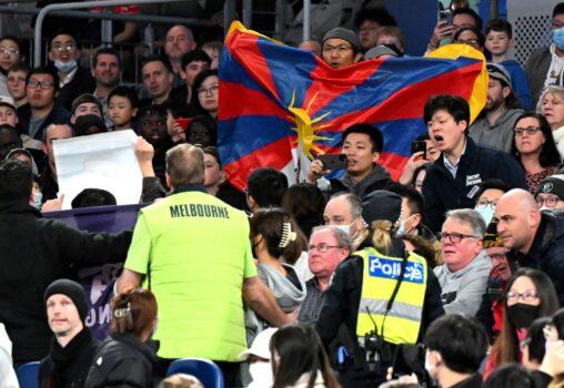 Members of security (in yellow) try to remove protesters from the stadium during the FIBA Basketball World Cup 2023 qualifying game between Australia and China in Melbourne on June 30, 2022. (William West/AFP via Getty Images)