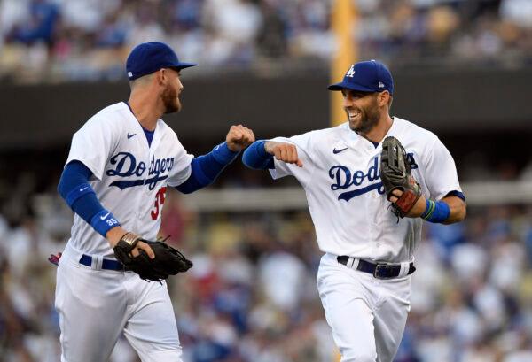 Chris Taylor #3 of the Los Angeles Dodgers is congratulated by Cody Bellinger #35 after completing a double play to end the second inning at Dodger Stadium, in Los Angeles, on June 30, 2022. (Kevork Djansezian/Getty Images)