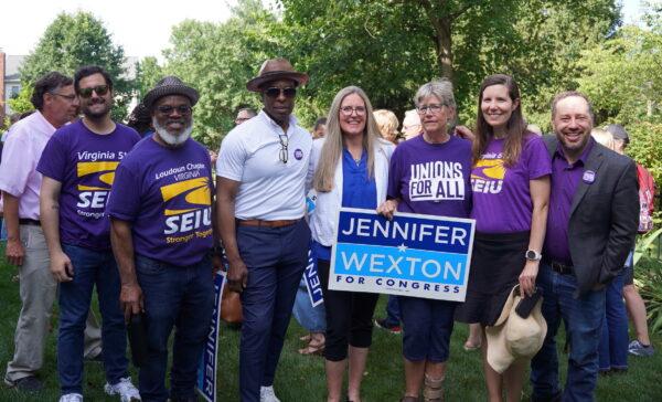 Congresswoman Jennifer Wexton (D-Va.) (4th R) with Service Employees International Union (SEIU) Virginia 512 president David Broder (R), Loudoun County Chair Junius Reynolds (5th R), and other members at Wexton’s reelection campaign kickoff event in Ashburn, Va., on June 20, 2022. (Terri Wu/The Epoch Times)