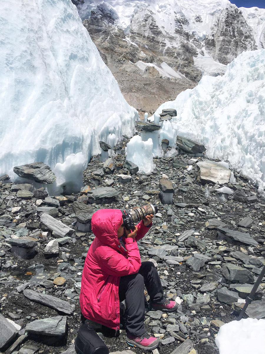 Celia capturing photos at the snowy Everest Base Camp. (Courtesy of Celia)