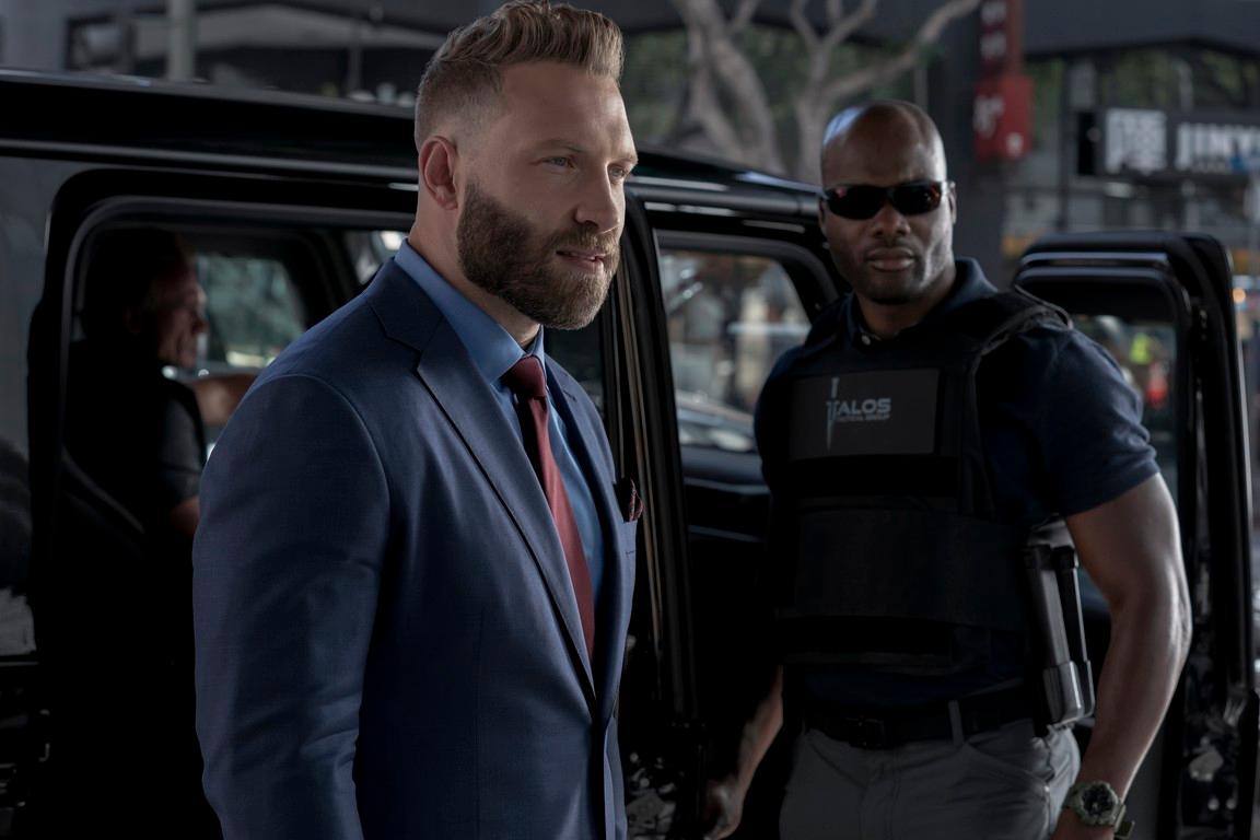 Steve Horn (Jai Courtney, L), president of wealth management group Capstone Industries, with his bodyguard, in "The Terminal List." (Fuqua Films/Amazon Studios)