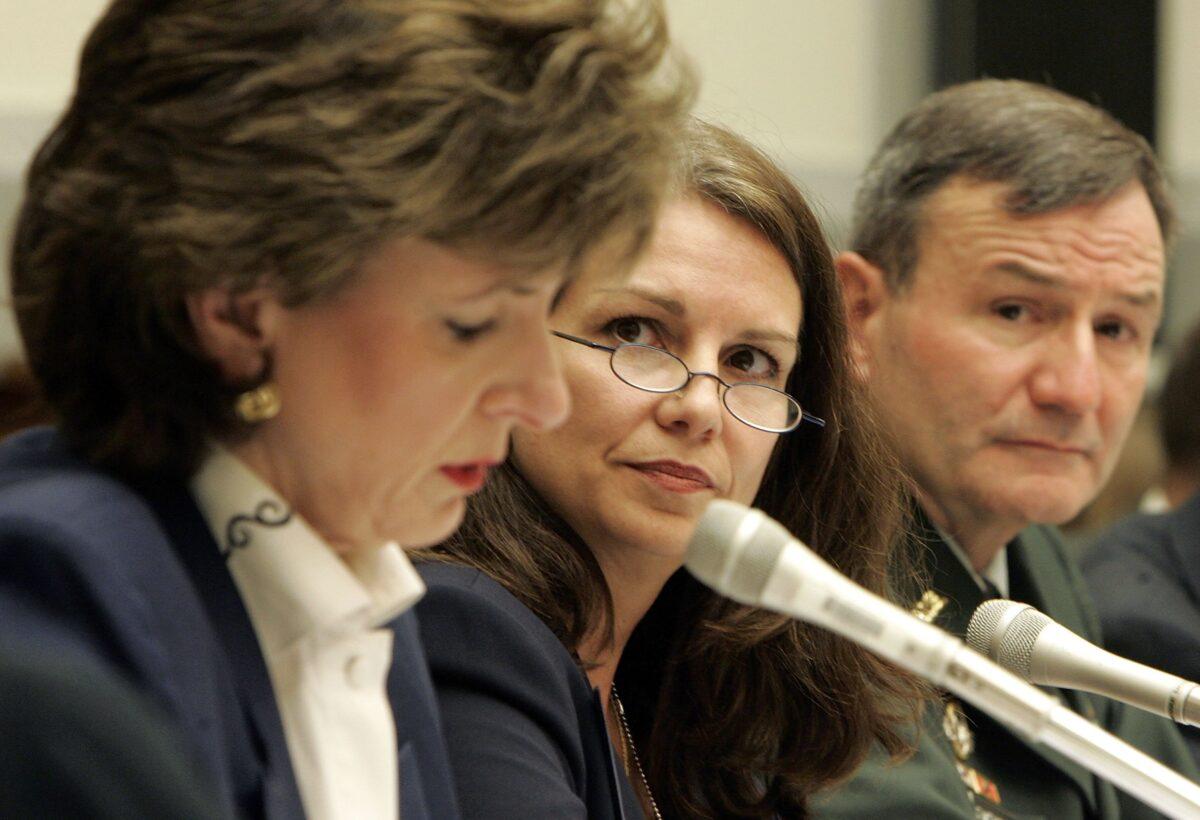 Principal Deputy Assistant Secretary of Defense for International Security Affairs Mary Beth Long (C) and Commander, Combined Forces Command - Afghanistan Lt. Gen. Karl Eikenberry listen to Drug Enforcement Agency Administrator Karen Tandy as she testifies before the House Armed Services Committee on the status of safety and security in Afghanistan, in Washington on June 28, 2006. (Joshua Roberts/Getty Images)