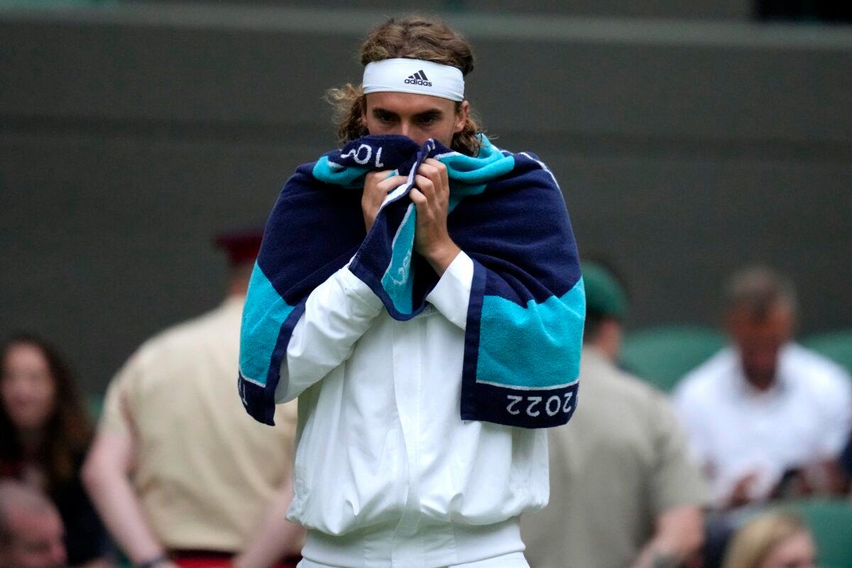 Greece's Stefanos Tsitsipas during a break in his third round men's singles match against Australia's Nick Kyrgios on day six of the Wimbledon tennis championships in London on July 2, 2022. (Kirsty Wigglesworth/AP Photo)