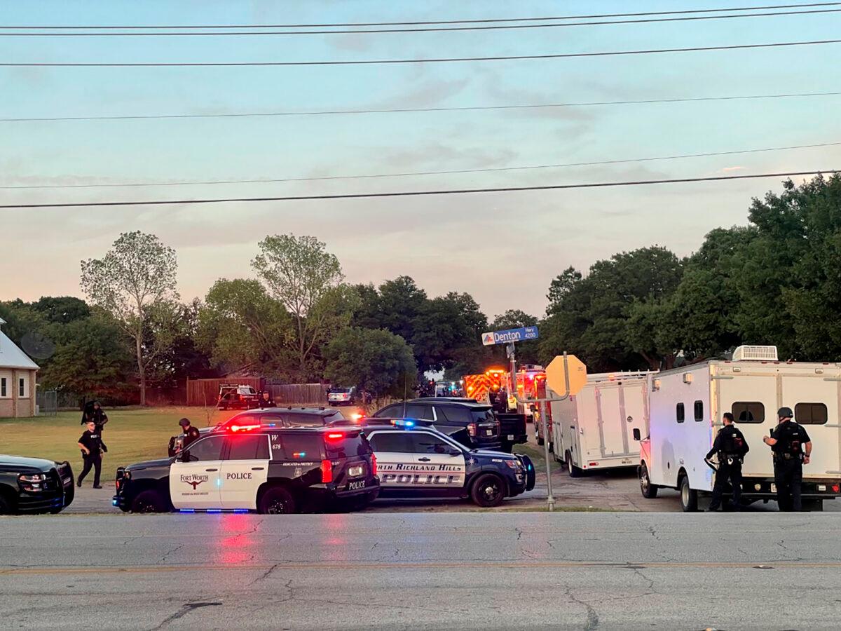 Law enforcement work the scene where multiple shots were fired near the area of Cedarcrest Drive and Diamond Oaks Drive in Haltom City, Texas, on July 2, 2022. (James Hartley/Star-Telegram via AP)