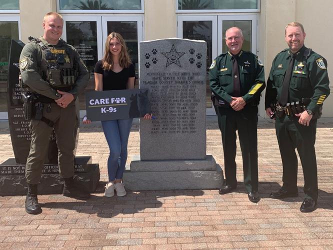 (L–R) Sgt. Robert Tarczewski, Emma Stanford, Sheriff Rick Staly, and Chief Jonathan Welker in Palm Coast, Fla., in June 2022. (Courtesy of Carmen Stanford via The Center Square)