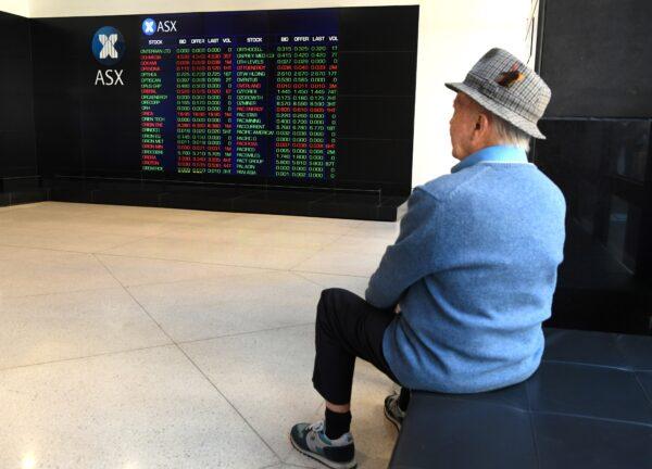 A man looks at the boards at the Australian Securities Exchange in Sydney, Australia, on Nov. 7, 2017. (William West/AFP via Getty Images)