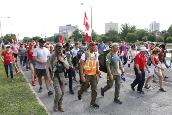James Topp walks with supporters towards the War Monument in Ottawa on June 30, 2022. (Noé Chartier/The Epoch Times)