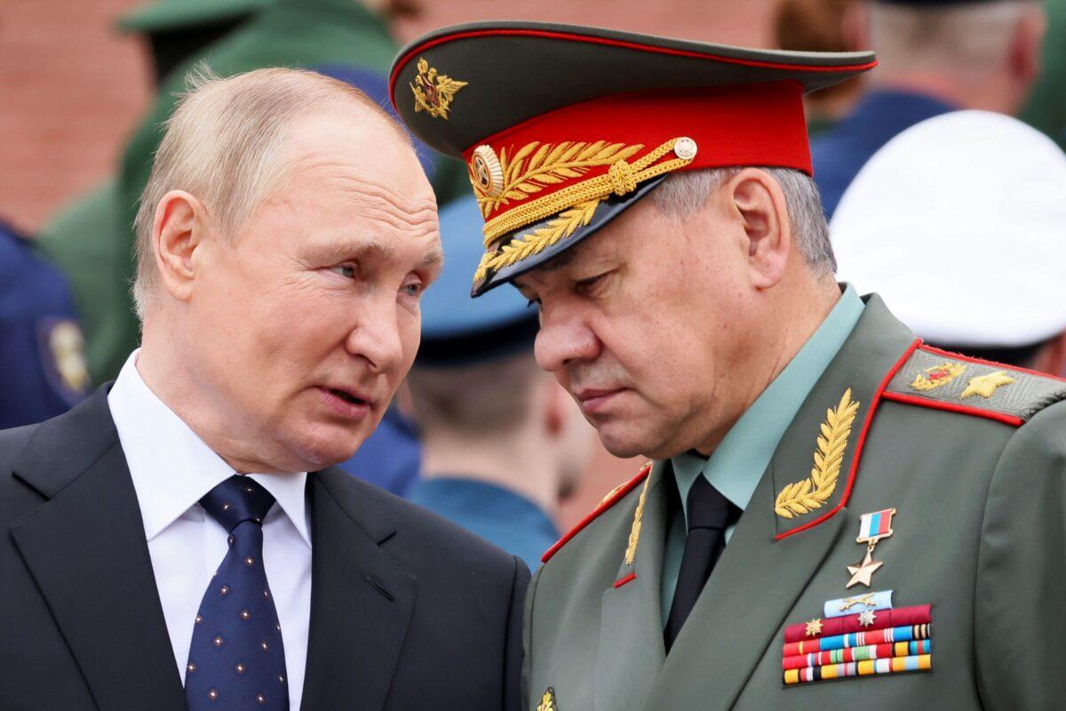 Russian President Vladimir Putin (L) speaks with Russian Defense Minister Sergei Shoigu during a wreath laying ceremony at the Tomb of Unknown Soldier in Moscow on June 22, 2022. (Mikhail Metzel/Kremlin Pool Photo via AP)