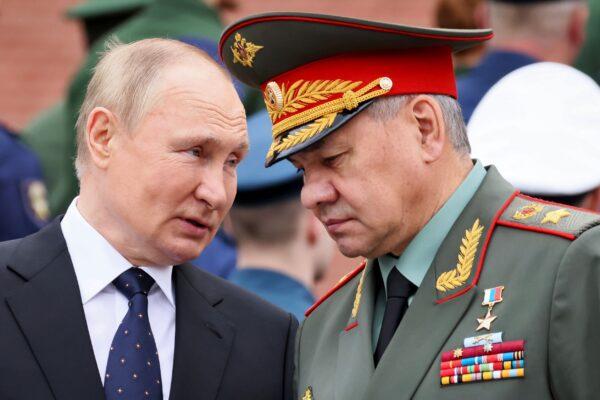 Russian President Vladimir Putin speaks with Russian Defence Minister Sergei Shoigu during a wreath laying ceremony at the Tomb of Unknown Soldier in Moscow, Russia, on June 22, 2022. (Mikhail Metzel/Sputnik/Kremlin Pool Photo via AP)