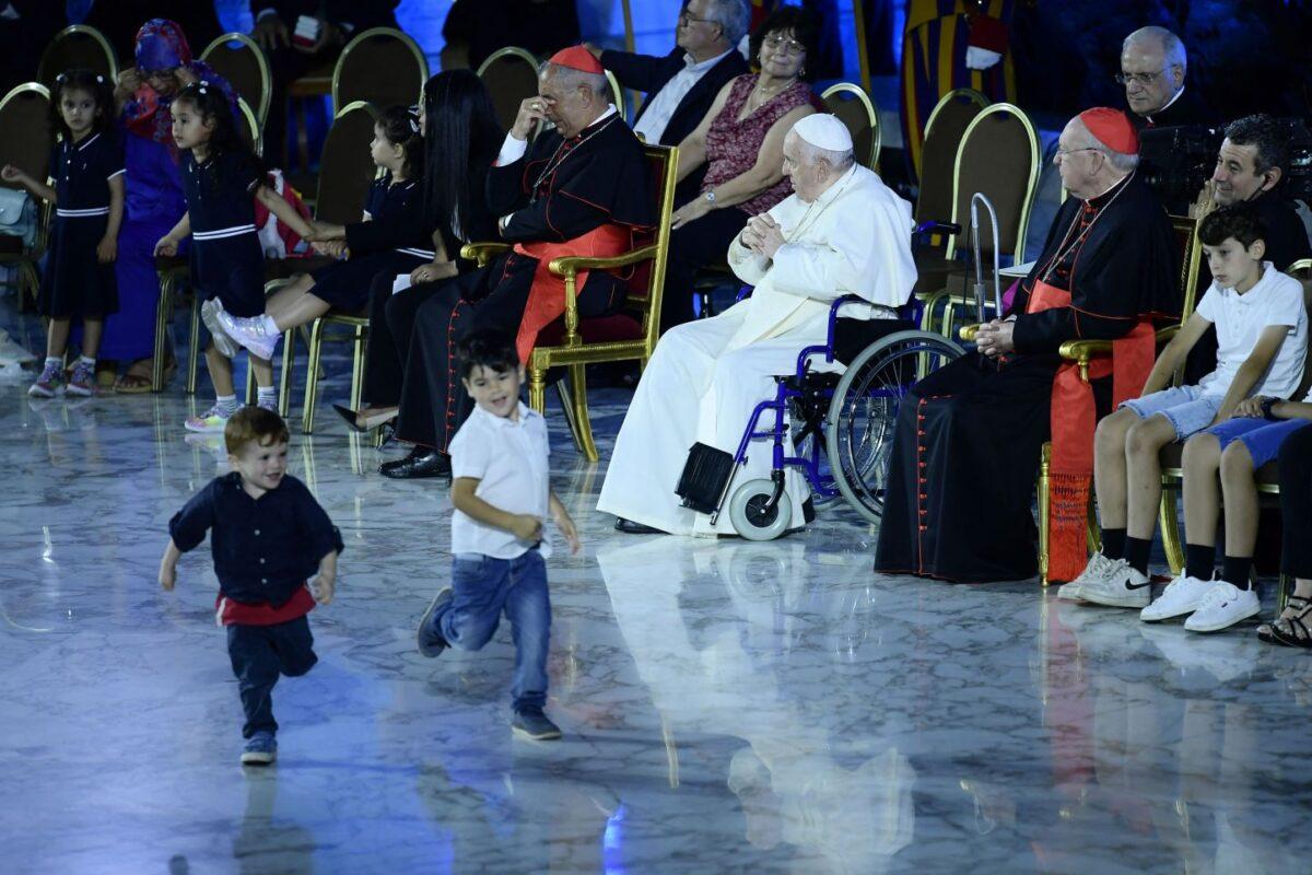 Children play onstage as Pope Francis, seated in a wheelchair following knee treatment, holds an audience as part of the Festival of Families - 10th World Meeting of Families, at Paul-VI hall in The Vatican on June 22, 2022. (Filippo Monteforte/AFP via Getty Images)