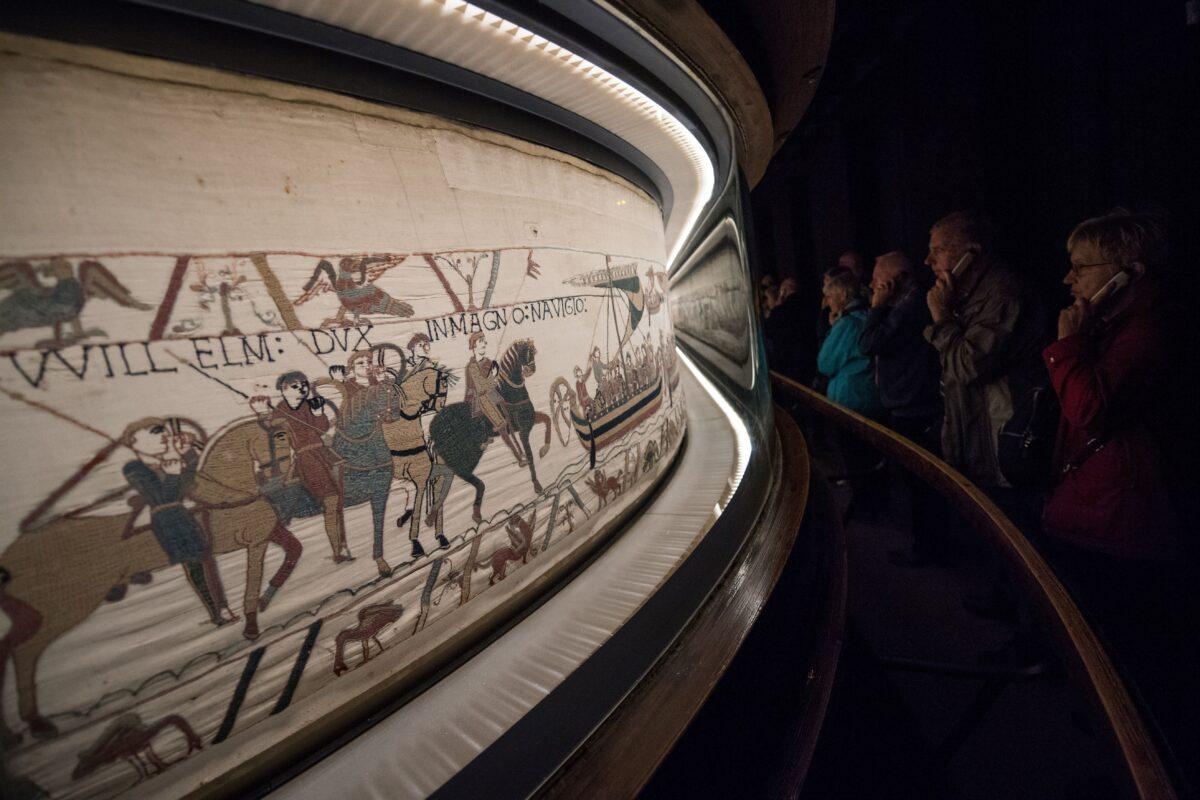 People look at the "Bayeux tapestry" or "Queen Mathilde tapestry," which relates Britain's conquest by William the Conqueror in 1066, in Bayeux, western France, on Sept. 13, 2019. (Loic Venance/AFP via Getty Images)