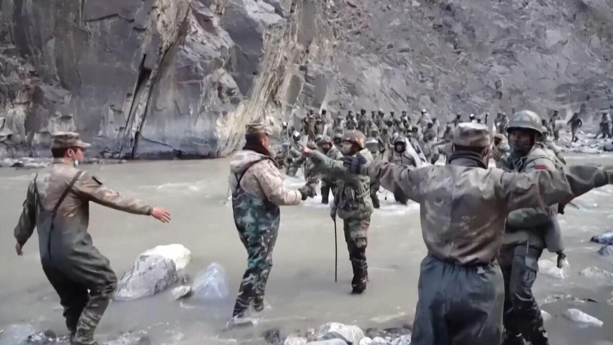 This video screenshot taken from footage recorded in mid-June 2020 and released by China Central Television (CCTV) on Feb. 20, 2021, shows Chinese (foreground) and Indian (background) soldiers during a clash on the Line of Actual Control (LAC) in the Galwan Valley. (AFP Photo/China Central Television)