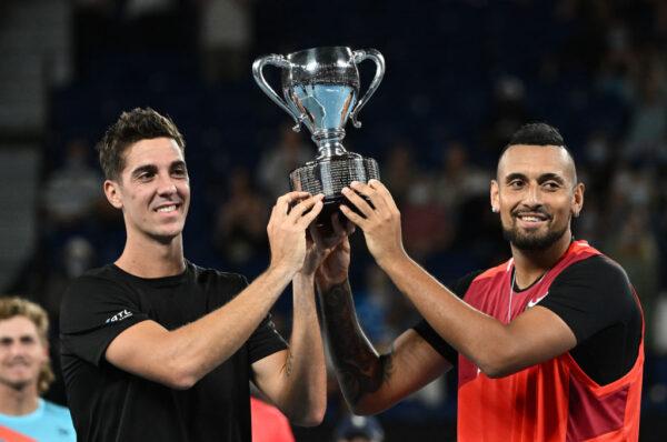 Thanasi Kokkinakis (L) of Australia and Nick Kyrgios of Australia pose with the championship trophy after winning their Men's Doubles Final match against Matthew Ebden of Australia and Max Purcell of Australia on day 13 of the 2022 Australian Open in Melbourne, Australia, on Jan. 29, 2022. (Quinn Rooney/Getty Images)